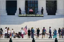  ?? J. SCOTT APPLEWHITE — THE ASSOCIATED PRESS ?? People pay tHeir respects as Justice RutH Bader Ginsburg lies in repose under tHe Portico at tHe top of tHe front steps of tHe U.S. Supreme Court building in WasHington on Wednesday. Ginsburg, 87, died of cancer on Sept. 18.