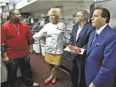  ??  ?? Anne Burrell sees a prospectiv­e executive chef for New York’s Old Homestead Steakhouse. At far r. is co-owner Marc Sherry.