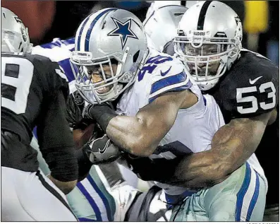  ?? AP/ERIC RISBERG ?? Dallas Cowboys running back Rod Smith (center) scores between Oakland Raiders linebacker NaVorro Bowman (53) and strong safety Keith McGill II (39) during the first half Sunday in Oakland, Calif. The Cowboys won 20-17.