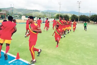  ??  ?? Participan­ts of the Kickers Football Academy summer camp go through their paces at the Mona Astro Turf.