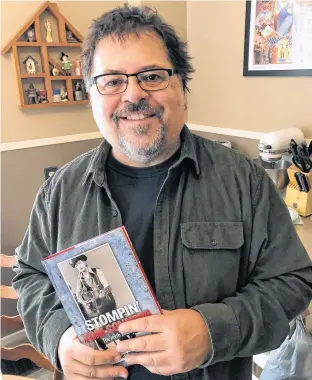  ?? DARRELL COLE/SALTWIRE NETWORK ?? Charlie Rhindress stands with a copy of his biography of Stompin’ Tom Connors: The Myth and The Man. He is hosting a series of streaming interviews with people who worked with or knew Stompin’ Tom.