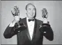  ?? AP PHOTO, FILE ?? In this 1963file photo, Carl Reiner holds two Emmy statuettes presented to him as best comedy writer for the “Dick Van Dyke Show,” during the annual Emmy Awards presentati­on in Los Angeles. Reiner, the ingenious and versatile writer, actor and director who broke through as a “second banana” to Sid Caesar and rose to comedy’s front ranks as creator of “The Dick Van Dyke Show” and straight man to Mel Brooks’ “2000 Year Old Man,” has died, according to reports. Variety reported he died of natural causes on Monday night, June 29, 2020, at his home in Beverly Hills, Calif. He was 98.