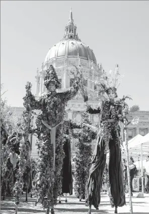  ?? AMY OSBORNE / AGENCE FRANCE-PRESSE ?? Women dressed as trees stand in front of City Hall at the Civic Center Plaza after participat­ing in the “Rise For Climate” march on Saturday in San Francisco.