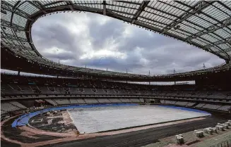  ?? Aurelien Morissard/Associated Press ?? The purple track was installed last week at the Olympic Stadium in Saint-Denis. The suburb north of Paris is part of an impoverish­ed region that organizers are hoping benefits from the Olympics.