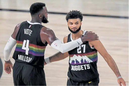  ?? AAron Ontiveroz, The Denver Post ?? Denver’s Jamal Murray, right, celebrates a Game 3 win over the Lakers with teammate Paul Millsap on Tuesday.