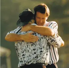 ?? Dave Martin / Associated Press 1996 ?? Nick Faldo (facing) hugs Greg Norman on the 18th hole at Augusta National. Faldo overtook Norman in the final round.