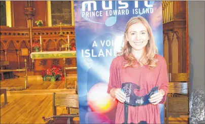  ?? SALLY COLE/JOURNAL PIONEER ?? Alicia Toner displays her SOCAN Songwriter of the Year Award for her song, “Back to Fine,” presented Thursday night at St. Paul’s Church in Charlottet­own at the first of the ticketed shows for 2018 Credit Union Music P.E.I. Week.