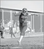  ??  ?? Senior Morgan Bello scores the winning run for Redwood during its softball game against San Rafael in Larkspur on Wednesday. Redwood won 2-1 in the bottom of the eighth.