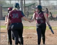  ??  ?? Siloam Springs senior Micah Curry (34) greets Hilarie Buffington (left) and Maggie Torres after they scored runs in the first inning Siloam Springs defeated Providence 15-4 in five innings.
(NWA Democrat-Gazette/Graham Thomas)