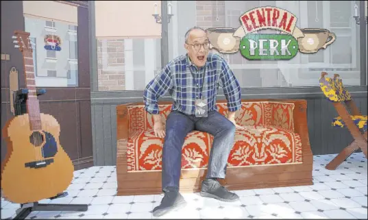  ?? Erik Verduzco Las Vegas Review-Journal @Erik_Verduzco ?? David Crane, co-creator of the TV show “Friends,” sits on a couch in a Lego replica of the sitcom’s famous Central Perk coffee shop set at the “Friends” Fan Experience at New York-New York on Saturday. The replica used about 975,000 Lego bricks.