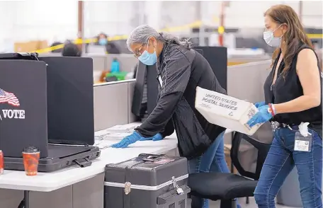  ?? ADOLPHE PIERRE-LOUIS/JOURNAL ?? Sandra Hernandez, left, and Geri Sanchez manually tabulate some rejected absentee ballots from primary voting Tuesday during processing at the Bernalillo County Bureau of Elections Voting Machine Warehouse.