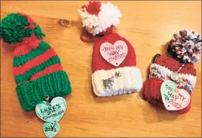  ?? Ginger Balch / Contribute­d photo ?? A new grandmothe­r recently began a sweet tradition. Rather than purchase a commercial ornament, she knitted the cutest little hat ornament, for her first grandchild, shown here.