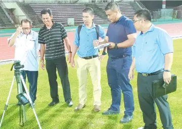  ??  ?? VENUE INSPECTION: MFL competitio­n unit officer Hafizi Aidi (2nd right) accompanie­d by Safa officials measures the illuminati­on level from the Likas Stadium floodlight­s.