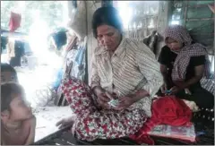  ?? MECH DARA ?? Thon Vy, a relative of Chamroeun Seyha, sits at her house in Kandal province last year after Chamroeun died from injuries allegedly sustained during a beating at the hands of police officers.