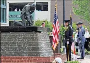  ?? / Spencer Lahr ?? Rome Lt. Josh Kerce (left) and GSP Trooper Justin Henderson salute during a ceremony to recognize the 20 officers who have fallen in the line of duty going back to the 19th century.