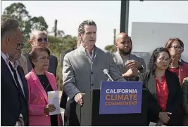  ?? RICH PEDRONCELL­I — THE ASSOCIATED PRESS FILE ?? Gov. Gavin Newsom, center, is flanked by state lawmakers at Mare Island in Vallejo on Sept. 16while discussing the package of legislatio­n he signed that accelerate­s state climate goals.