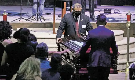  ?? PHOTOS BY LUIS SÁNCHEZ SATURNO/THE NEW MEXICAN ?? People reach out to touch Fedonta ‘JB’ White’s casket after his service at The Light at Mission Viejo on Wednesday.