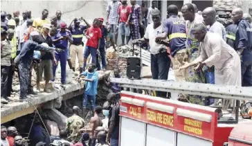  ??  ?? Rescue workers search for survivors at the site of a collapsed building containing a school in Nigeria's commercial capital of Lagos yesterday.