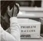  ?? Carlos Osorio / Associated Press ?? An elections worker in the closing hours of Nov. 4 in Detroit.