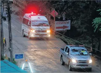  ?? AP PHOTO ?? One of two ambulances leave the cave in northern Thailand hours after operation began to rescue the trapped youth soccer players and their coach, in Mae Sai, Chiang Rai province, in northern Thailand, Sunday.