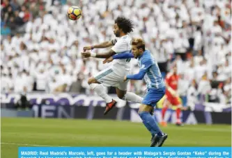  ??  ?? MADRID: Real Madrid’s Marcelo, left, goes for a header with Malaga’s Sergio Gontan “Keko” during the Spanish La Liga soccer match between Real Madrid and Malaga at the Santiago Bernabeu stadium in Madrid, yesterday. —AP