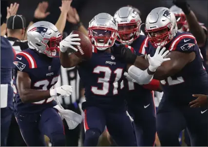  ?? NANCY LANE / BOSTON HERALD FILE ?? Patriots defensive back Jonathan Jones celebrates his intercepti­on during a game against the Miami Dolphins this season. The Patriots face a tough Dallas Cowboys offense today.