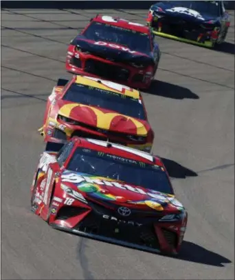  ?? RALPH FRESO - THE ASSOCIATED PRESS ?? Kyle Busch (18) drives out of Turn 4 during the Monster Energy Cup Series race at ISM Raceway on March 10 in Avondale, Ariz.