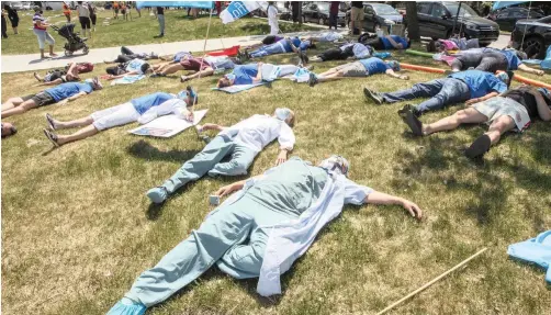  ?? | RYAN REMIORZ AP ?? HEALTH-CARE workers demanding time off for Covid-19 fatigue stage a lie-in in front of Maisonneuv­e Rosemont Hospital in Montreal, Canada, on Wednesday.