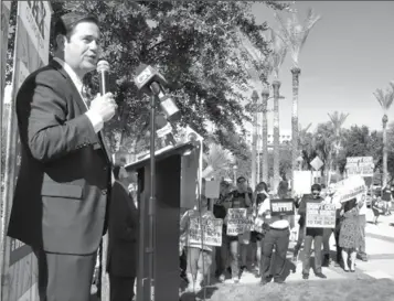  ?? PHOTO BY HOWARD FISCHER/CAPITOL MEDIA SERVICES ?? GOV. DOUG DUCEY TOUTS THE CONCEPT – BUT NOT THE SPECIFICS – of the Republican tax plan Monday at the state Capitol as protestors state their case that it is simply relief for corporatio­ns and the wealthy.