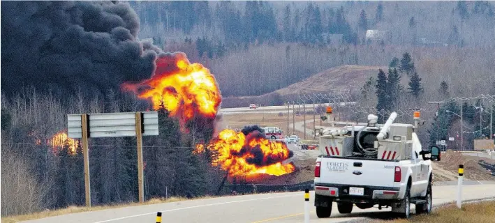  ?? JASON FRANSON/EDMONTON JOURNAL ?? A controlled burn is performed two days after 13 tanker cars carrying liquefied petroleum gas went off a track near Gainford in October. Railways now must tell cities what goods pass through.