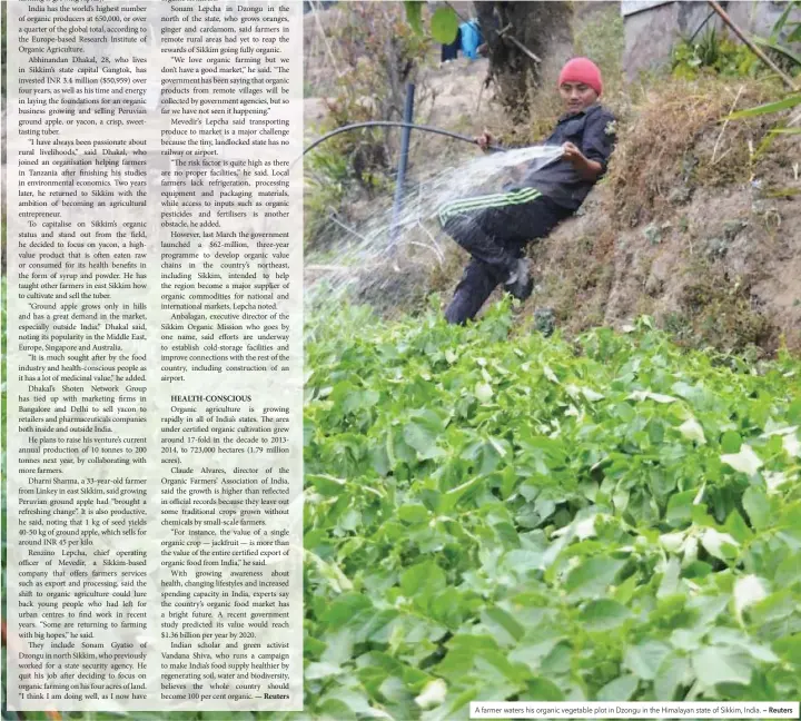  ?? — Reuters ?? A farmer waters his organic vegetable plot in Dzongu in the Himalayan state of Sikkim, India.