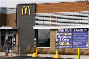  ?? (AP/Nam Y. Huh) ?? A hiring sign sits Thursday outside of McDonald’s in Buffalo Grove, Ill. The number of applicatio­ns for unemployme­nt benefits nationally rose sharply last week.