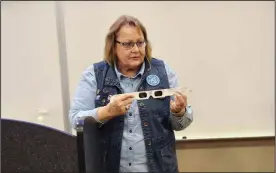  ?? David Jacobs/sdg Newspapers ?? Deloris Mlay, president of the Richland Astronomy Society, led an eclipse presentati­on at the Pioneer Career and Technology Center in Shelby. She is holding special glasses.