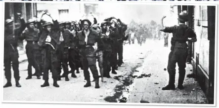  ?? ?? BLOODY AFTERMATH: Allied casualties and a wrecked tank on Dieppe’s beach, top. Above: Troops taken prisoner