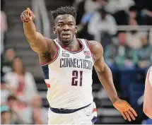  ?? C. Morgan Engel/Getty Images ?? The University of Connecticu­t’s Adama Sanogo gestures as he moves up court during the second half against Saint Mary’s during the second round of the NCAA Tournament.