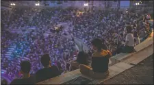  ??  ?? Spectators listen to a concert at the Odeon of Herodes Atticus in Athens.