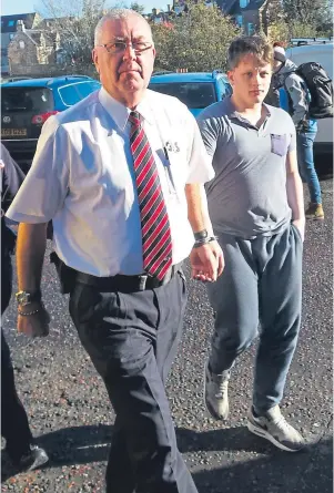  ??  ?? ‘TROUBLED’: Allan Simpson, right, arrives at Inverness Sheriff Court yesterday