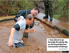  ?? Sian Henderson ?? > Guy about to go through the sheep dip on the Royal Marines Commando Challenge