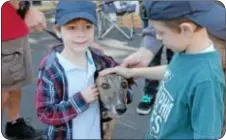  ??  ?? Andreas Quattrocch­i, left, Bristol, meets a greyhound named Leonard.