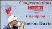  ?? [AP PHOTO] ?? Australia’s Cameron Davis kisses his trophy after winning the Australian Open on Sunday in Sydney.