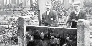  ??  ?? Sightseers pose for a picture in an archive shot of the old Oswaldtwis­tle stocks, which are set to be restored by the Rotary Club