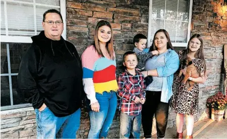  ?? ADRIAN SAINZ/AP ?? KeithMicha­el, left, seen with his children, lost his wife to COVID-19. Susanne Michael, a fourth grade teacher, was 47 when she died in October.