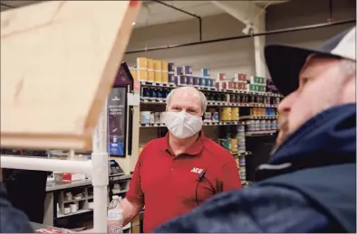  ?? Yehyun Kim / CTMirror.org ?? Peter Broggi, center, talks to a customer, Nate Cecchinatl. Cecchinatl said he is fully vaccinated and chose not to wear a mask in the store because the store doesn't require.