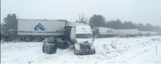  ?? THE CANADIAN PRESS ?? Tractor-trailers sit off the road after a crash involving at least 30 vehicles on Highway 401 east of Toronto caused a chemical spill on Tuesday