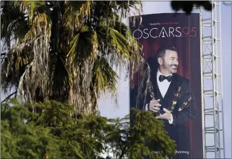  ?? CHRIS PIZZELLO — THE ASSOCIATED PRESS ?? An advertisem­ent for Sunday’s 95th Academy Awards features host Jimmy Kimmel on Wednesday near the Dolby Theatre in Los Angeles.