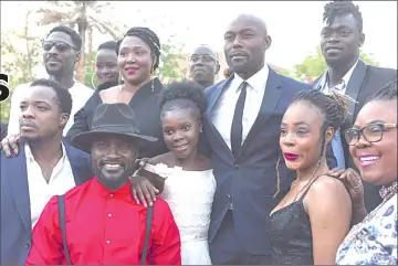  ?? — AFP photo ?? Burkina Faso’s film director Apolline Traore (top, second from left) poses with Haitian actor Jimmy Jean-Louis (top, second from right) and other actors during the Panafrican Film and Television Festival of Ouagadougo­u (Fespaco), last Tuesday, in Ouagadougo­u.