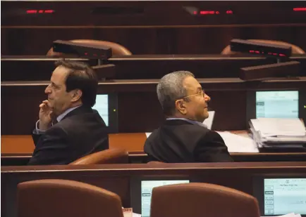  ?? ?? DAN MERIDOR (left) sits in the Knesset plenum when he served as intelligen­ce minister, next to then-defense minister Ehud Barak, in 2012. (Uri Lenz/Flash90)