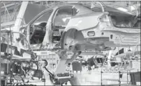  ?? ERIK SCHELZIG/AP FILE ?? An employee works on a Passat sedan at the Volkswagen plant in Chattanoog­a, Tenn.