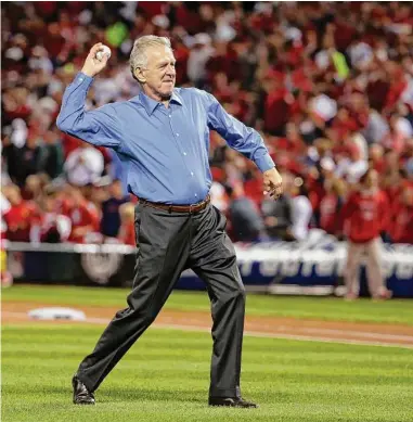  ?? Charles Rex Arbogast/Associated Press ?? Broadcaste­r Tim McCarver throws the ceremonial first pitch before Game 3 of the 2014 NL Division Series between the St. Louis Cardinals and the Los Angeles Dodgers in St. Louis.