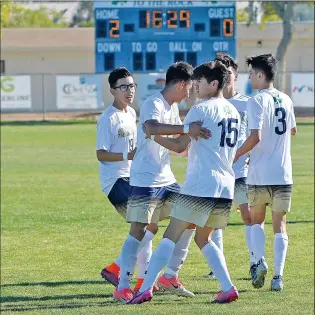  ?? Buy this photo at YumaSun.com PHOTO BY RANDY HOEFT/YUMA SUN ?? YUMA CATHOLIC’S JONAH FRANCO (15) is congratula­ted by his teammates after scoring in the second half of Saturday’s 3A state tournament quarterfin­al game against PhoenixNFL Yet Academy at Ricky Gwynn Stadium. YC won, 2-0. The No. 2 Shamrocks, in search...